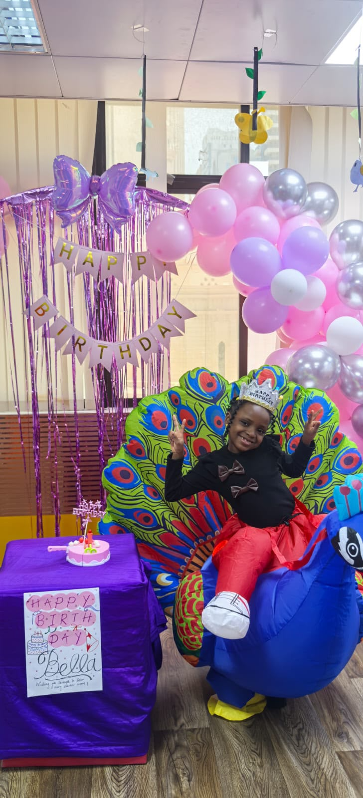 Birthday celebration setup at Angels Garden with balloons and dummy cake